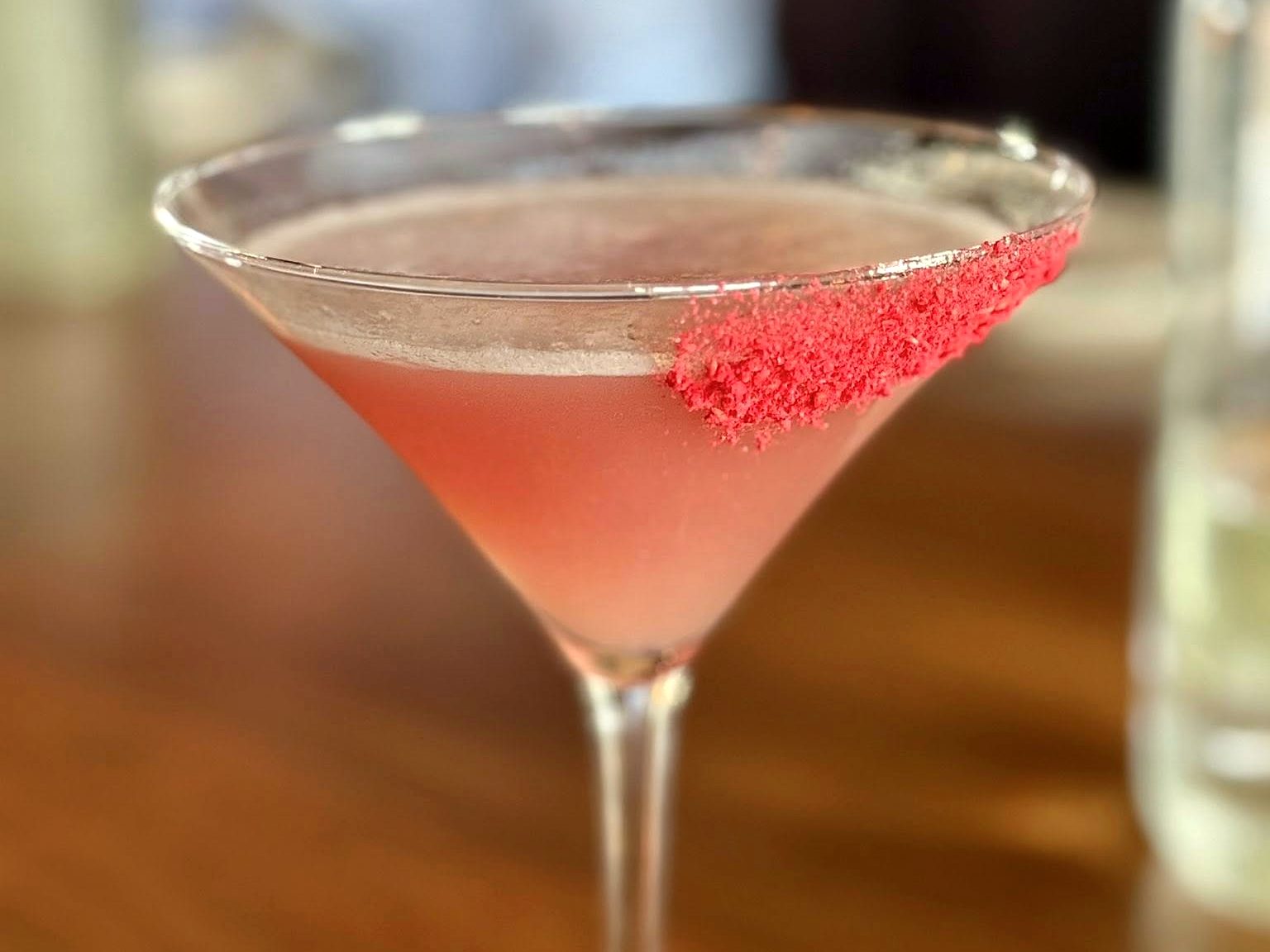 A blush-pink martini at Osteria Bianchi, rimmed with a crust of crushed freeze-dried raspberries.