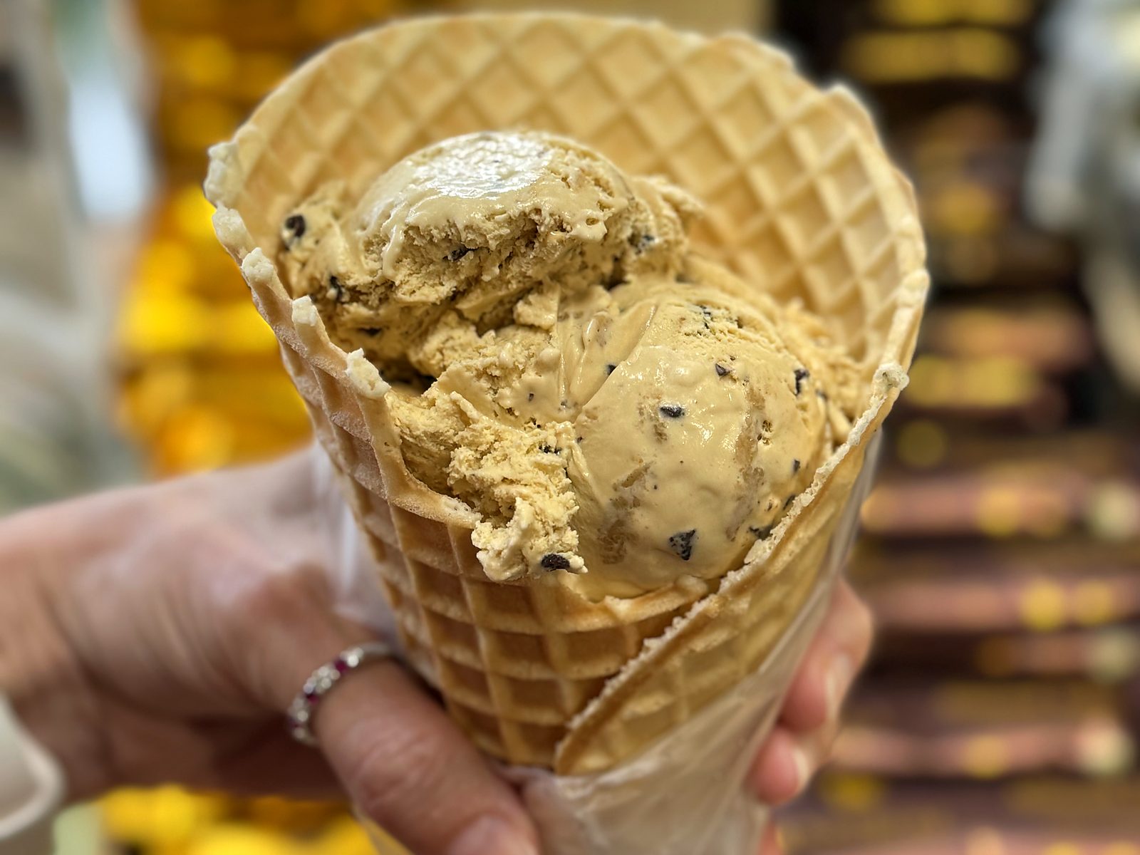 Graham Central Station ice cream at Enstrom &mdash; two scoops of golden graham ice cream shot through with dark chocolate flecks, packed into a waffle cone.