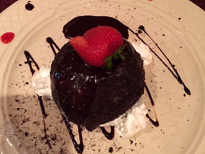 The tartufo at Jasper's — a chocolate-shelled gelato dome under fudge, whipped cream, and a strawberry.