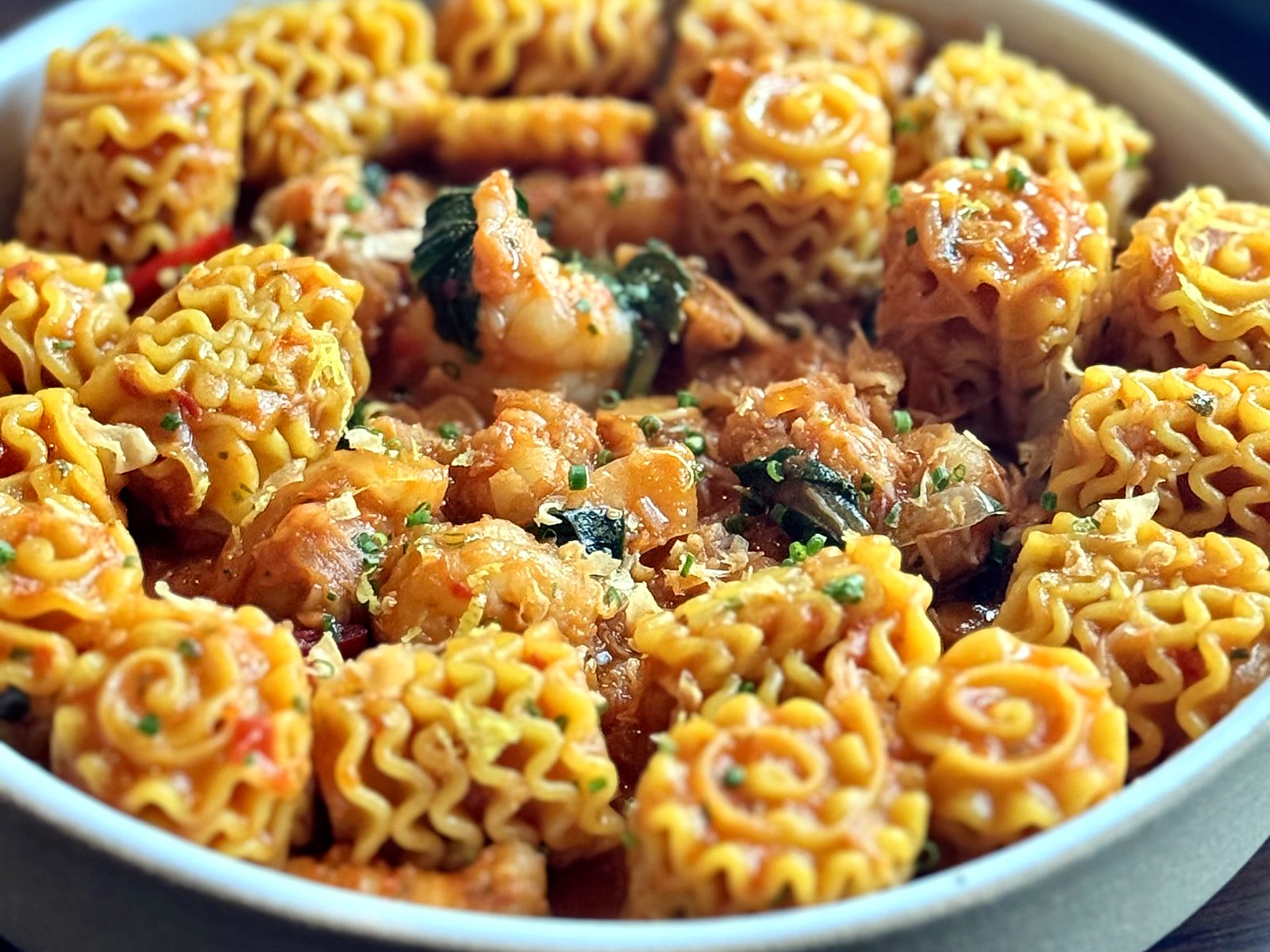 Lazia’s lobster mafaldine — ruffled ribbon pasta coiled into rosettes with shellfish, tomato, and lemon zest.