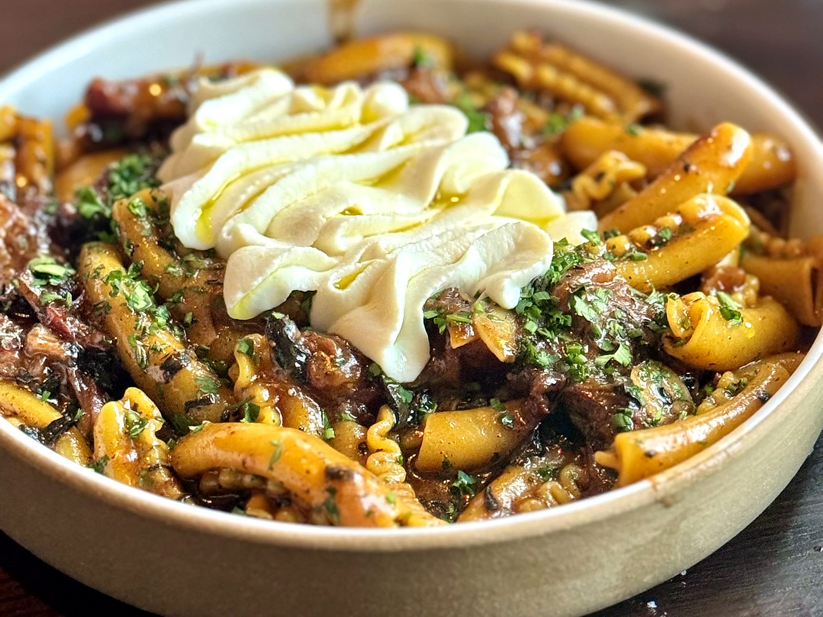 Radiatore at Lazia in a deep beef ragù, topped with a swirl of mascarpone and herbs.
