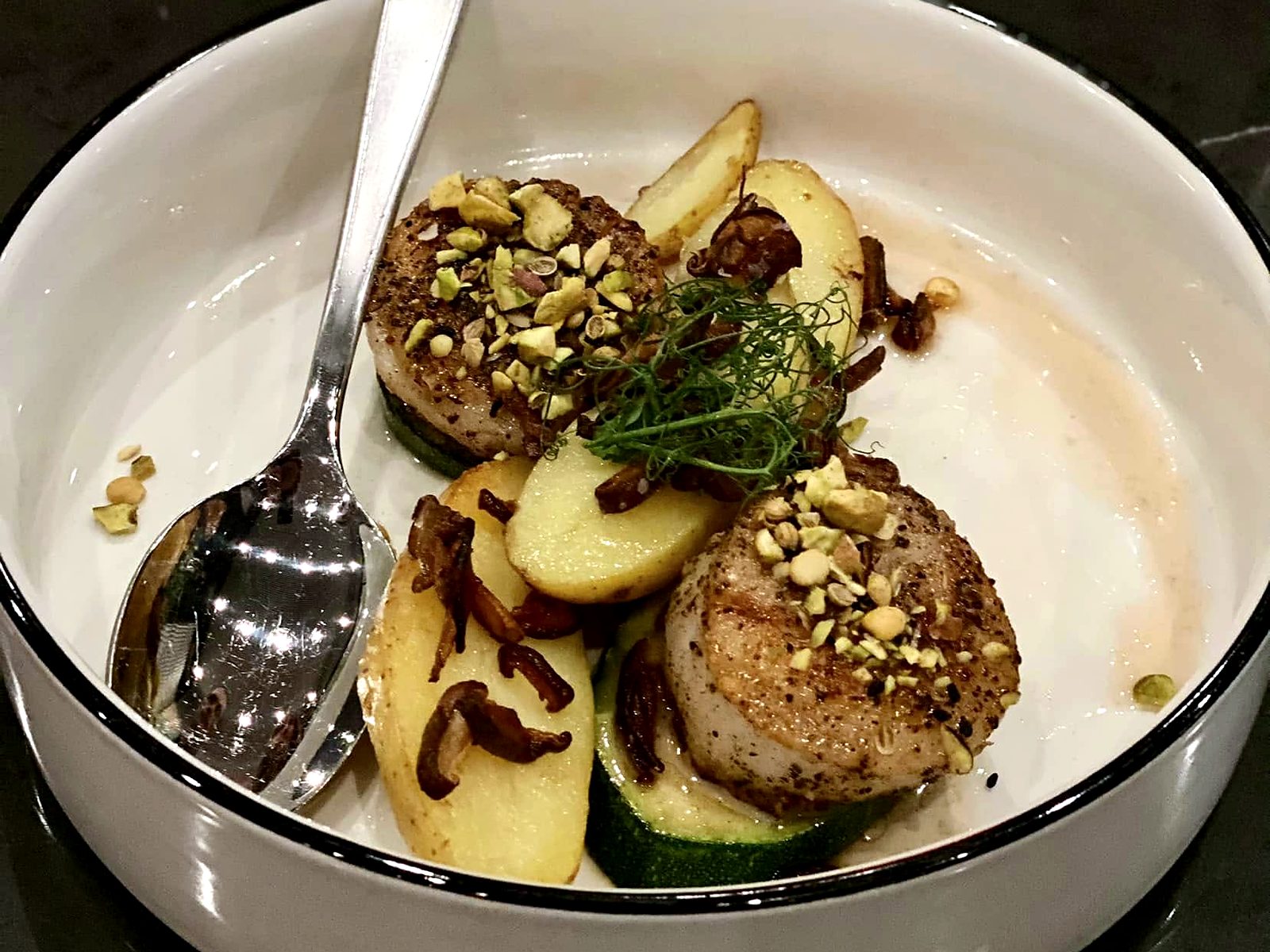 Pistachio-crusted scallops at Of Course Kitchen & Company over zucchini and fingerling potatoes.