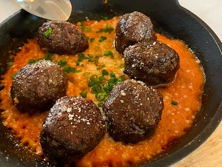 Keftedes at Paros — beef meatballs in ouzo tomato sauce, dusted with cheese and chives.