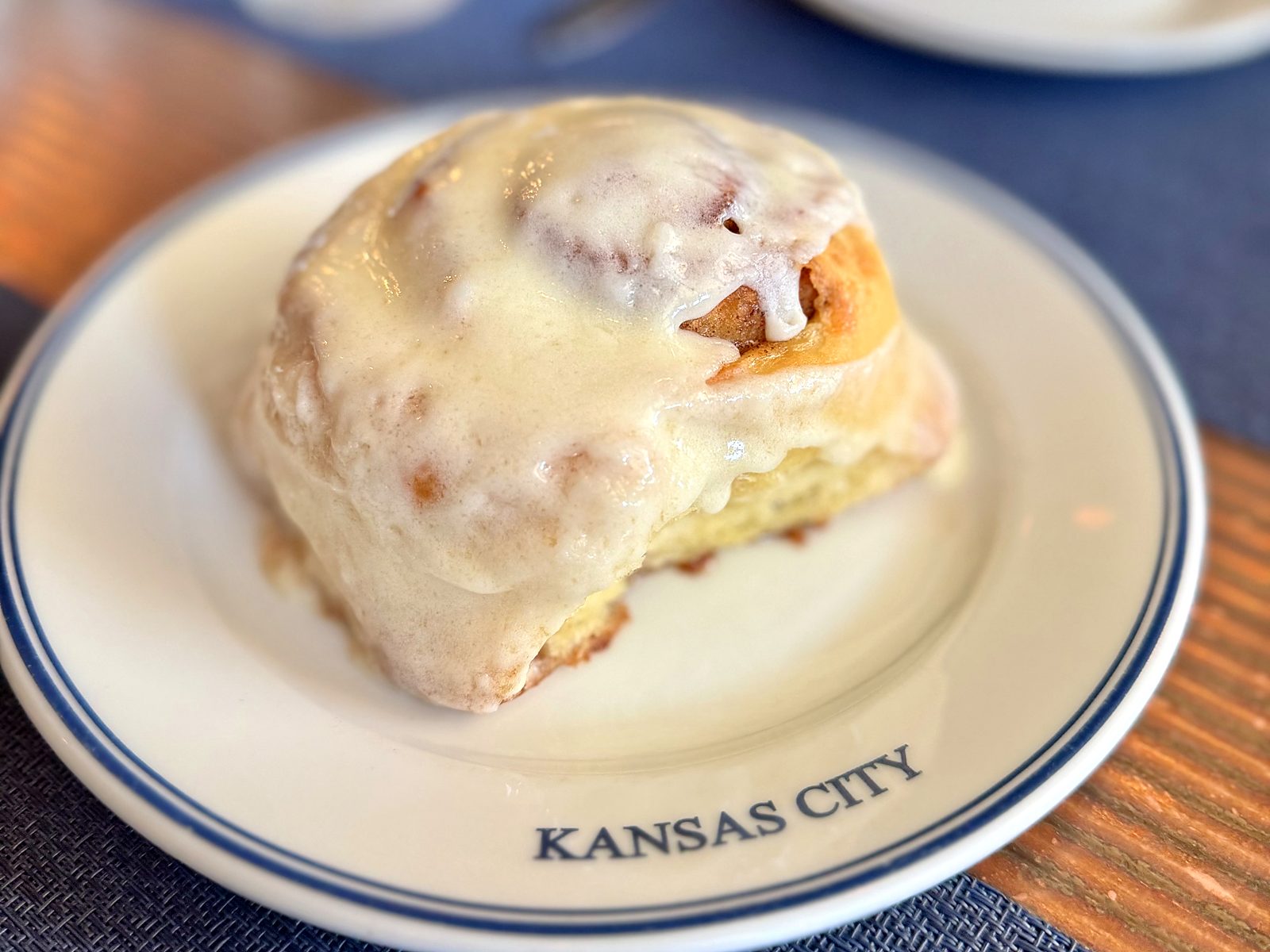 The cinnamon roll at Rye — a single iced roll, glaze sliding down the swirl.