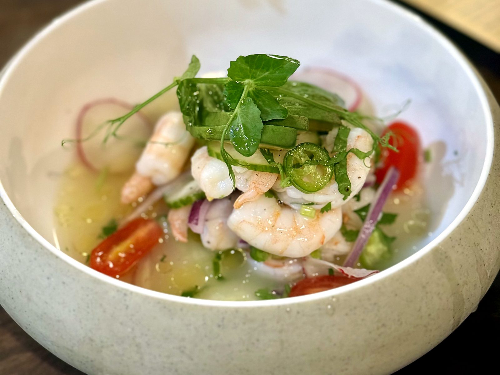 Shrimp ceviche at T’ähä — plump shrimp in citrus broth with avocado, serrano, cherry tomato, red onion, and pea shoots.