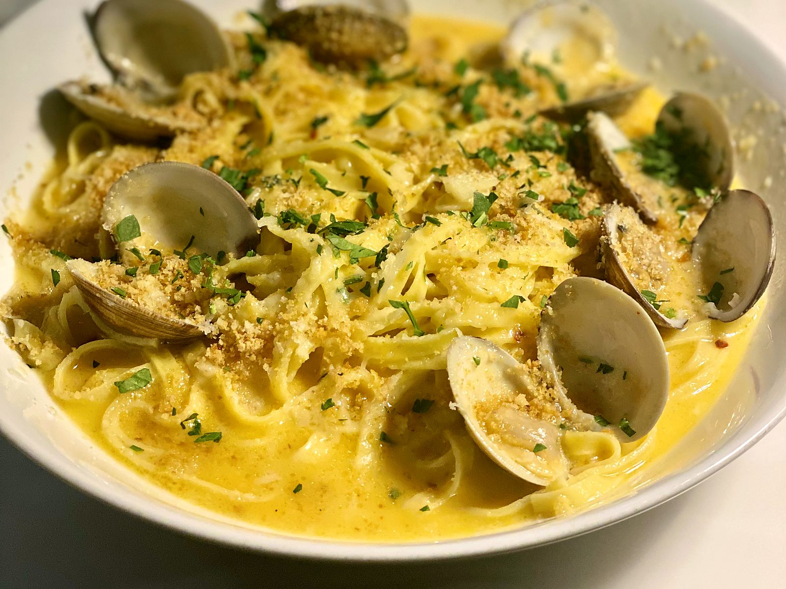 Linguini and clams at Verbena — hand-cut pasta ringed with countneck clams, toasted breadcrumbs, and parsley in a golden broth.